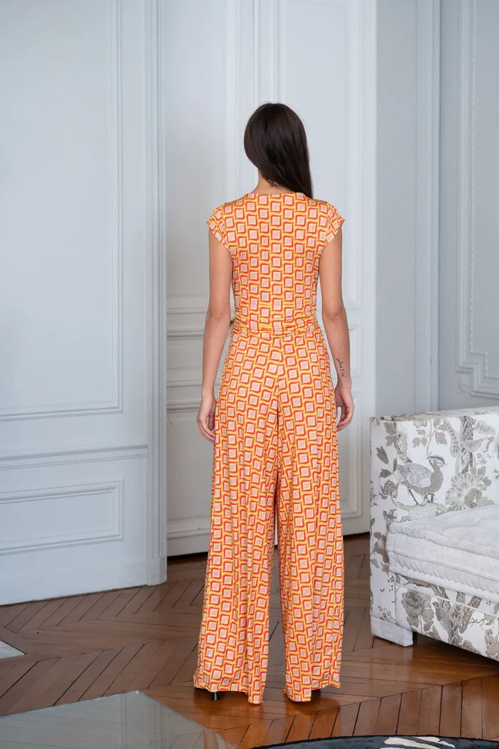 Model wears orange and white jumpsuit