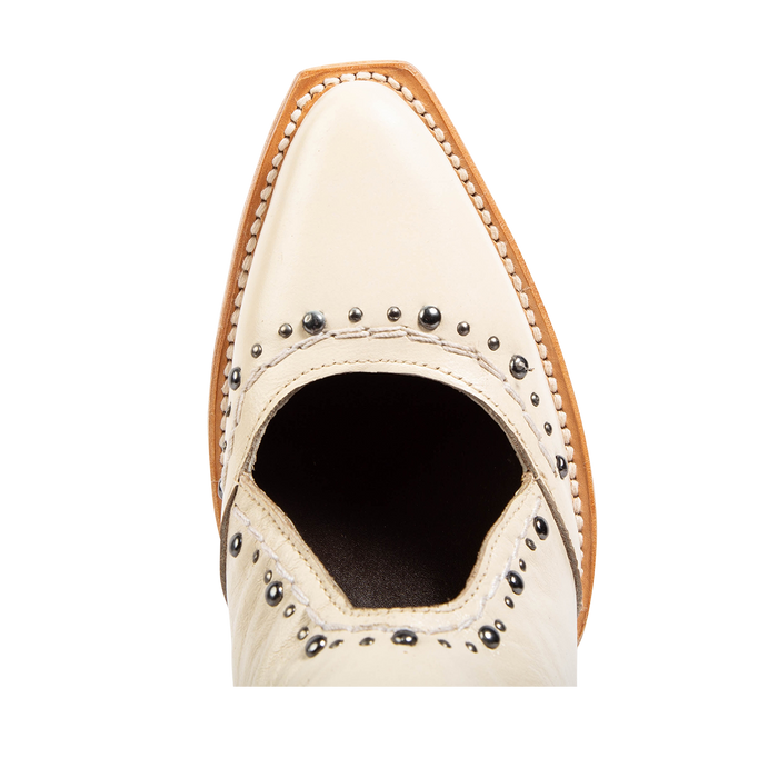 Top view showing a slim snip toe and open instep construction with silver stud detailing on FREEBIRD women's Melody beige leather shoe