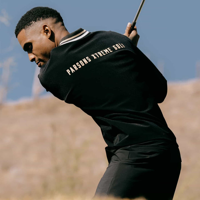 PXG men's black letterman pullover, lifestyle photo