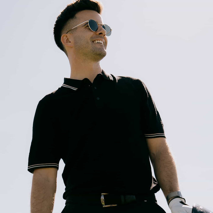 PXG men's black multi-logo jacquard knitted polo, lifestyle photo