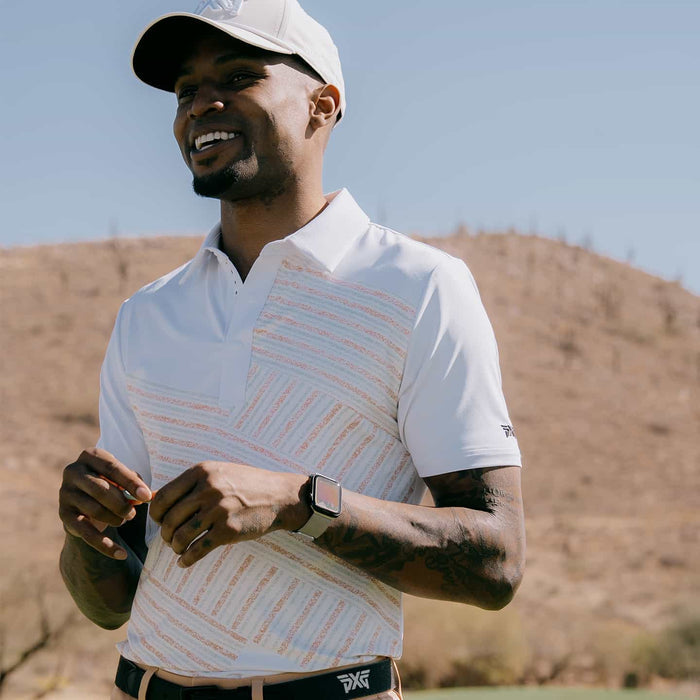 PXG men's white athletic fit victory flag polo, lifestyle photo