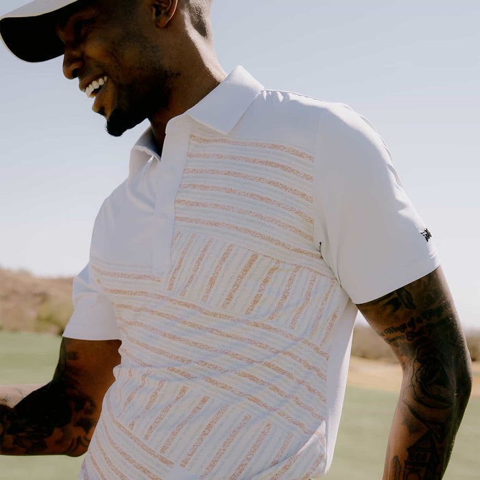 PXG men's white athletic fit victory flag polo, lifestyle photo