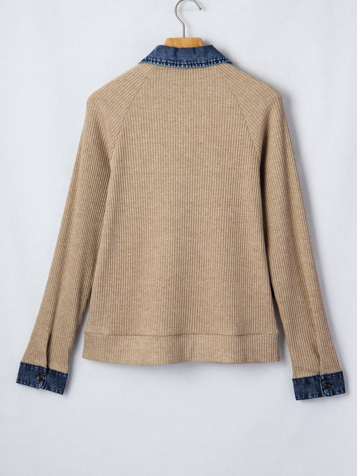 Beige ribbed sweater with blue trim on a white background
