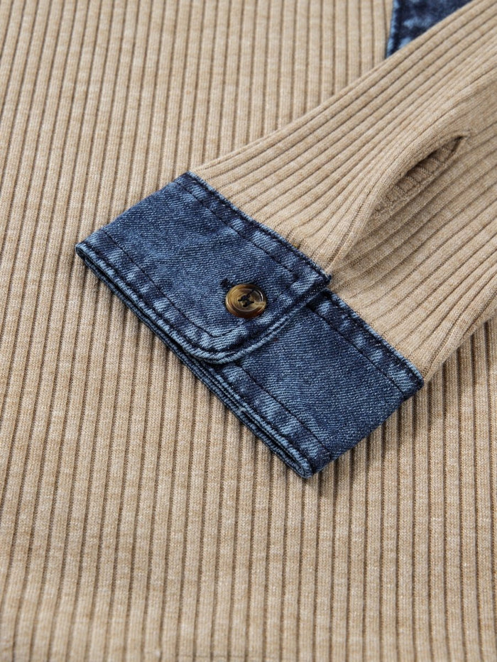 Close-up of a beige corduroy jacket with blue denim trim and button.