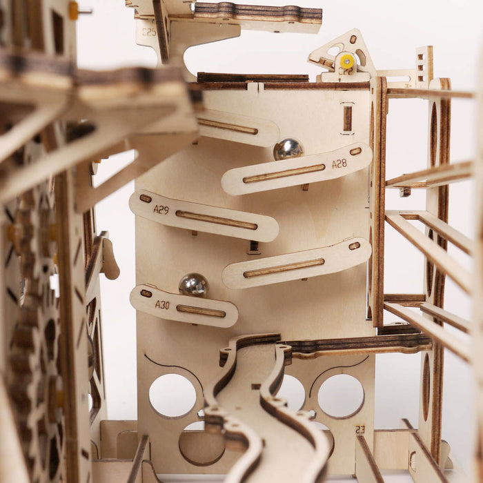 ROKR Marble Explorer wooden 3D puzzle close up showing spiral marble track and silver balls in motion