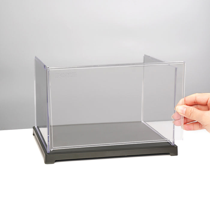 Robotime landscape acrylic display case with black base, hand placing it on plain white surface