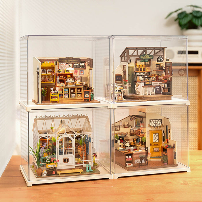 Four Rolife miniature dollhouses inside clear acrylic display cases stacked in 2 by 2 grid arrangement