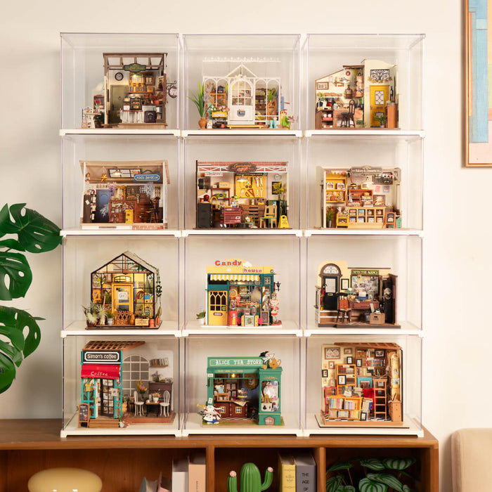 Wall display of twelve Rolife miniature dollhouses in clear acrylic cases arranged on a tall shelf