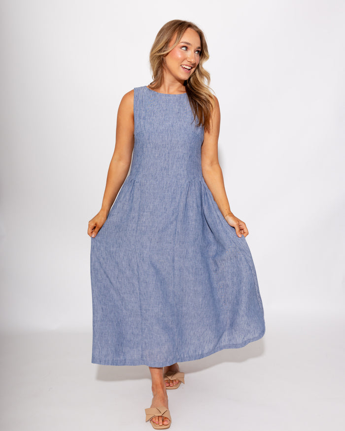 Light blue sleeveless pleated midi dress side view, A-line silhouette boutique dress at Gaudie & Co