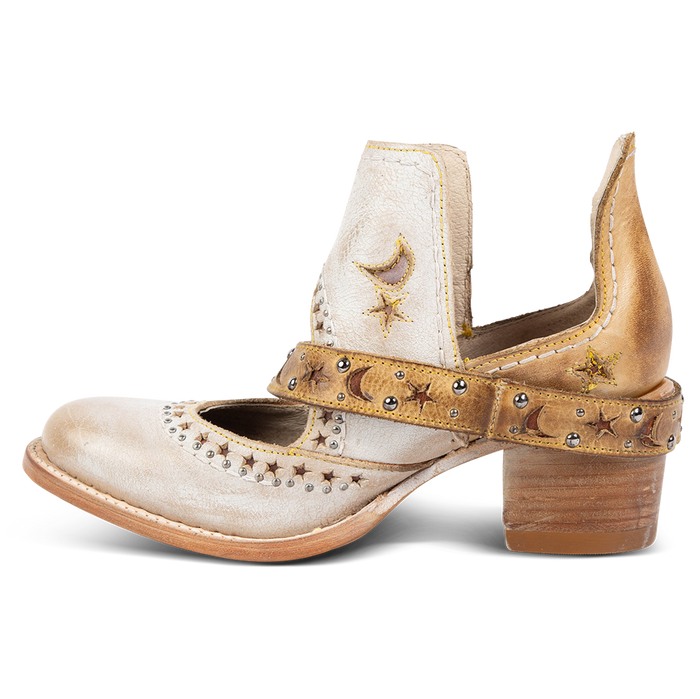 Side view showing a decorative ankle strap, silver stud detailing, and exposed ankles on FREEBIRD women's Stardom beige bootie
