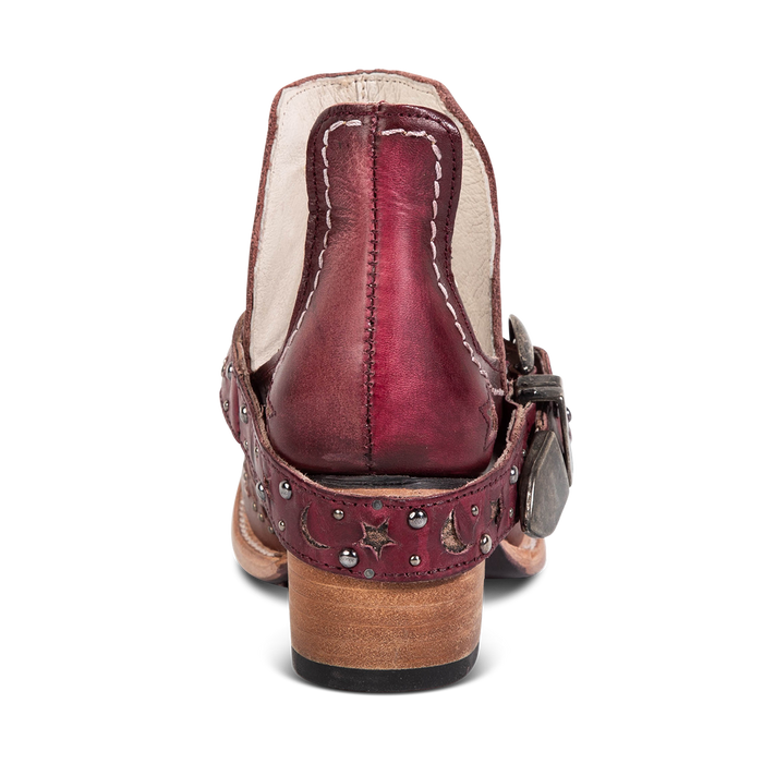 Back view showing a low stacked heel and decorative ankle strap on FREEBIRD women's Stardom wine bootie
