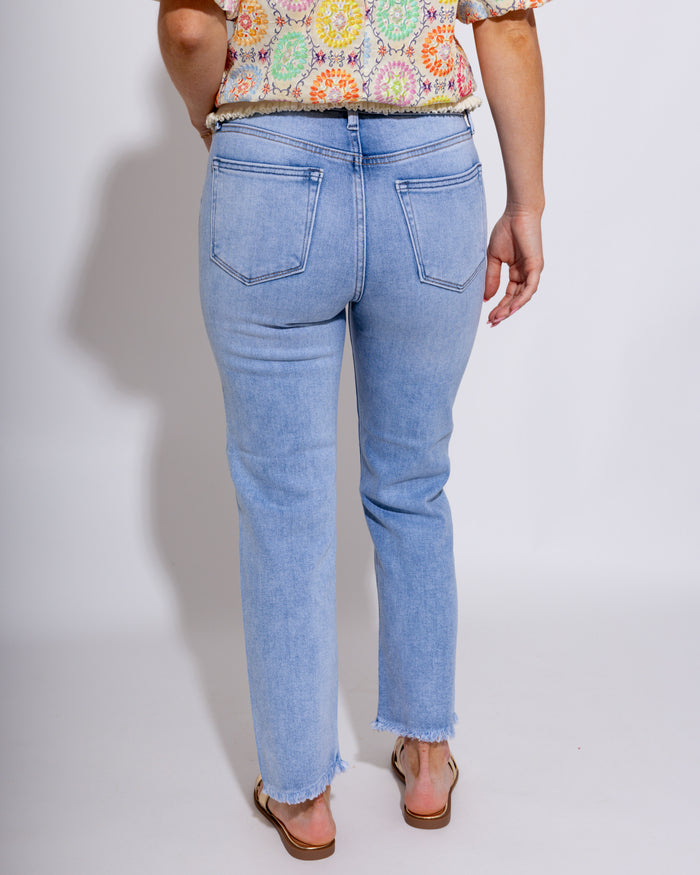 Mid-rise straight leg light wash denim jeans with fray hem detail, women's boutique denim at Gaudie & Co