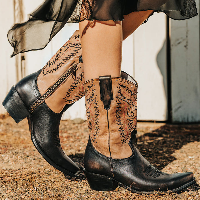 Black WESTROSE leather western boots with floral winged embroidery, snip toe, and metal stud detailing.