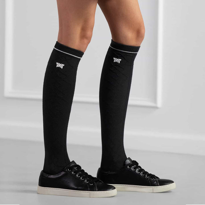 PXG women's black jacquard knee golf socks with a white PXG logo on a white background